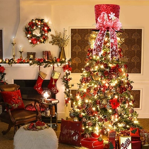 Detail of red sequined Christmas tree topper hat with snowflake bow in cozy home scene