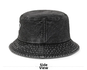 Close-up of heart embroidery and stitching on dark grey washed denim bucket hat