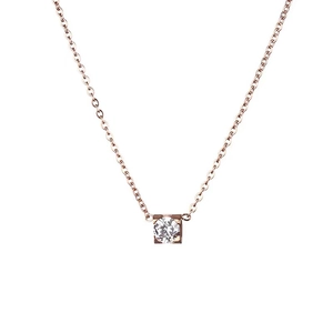Minimalist rose gold necklace with four-prong cubic zirconia solitaire pendant on white background