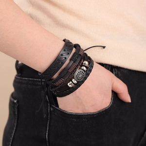 Four-piece multilayer leather bracelet set with braided rope and metal pendant detail