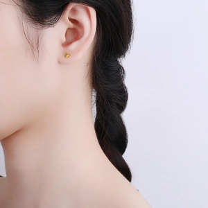Minimalist S925 sterling silver golden butterfly stud earrings worn on female ear