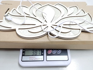 Detail shot of the Mandala Yoga Night Light on a scale showing 387g product weight