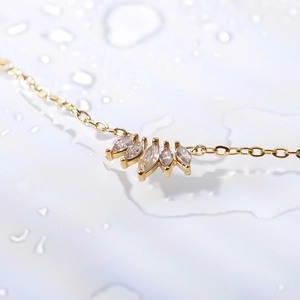 18k gold plated stainless steel necklace with marquise-cut zircon pendant on wet surface