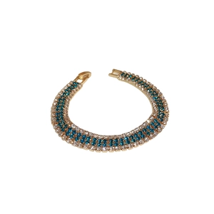 Vintage gold bracelet featuring pavé-set blue and white zircons with a secure jewelry clasp