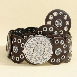 Detail of dark brown leather waist belt with floral metal rings and engraved western buckle