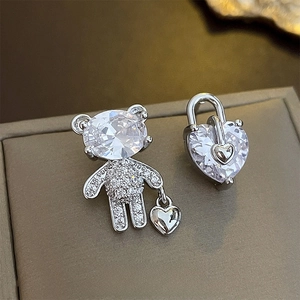 Asymmetric silver bear and heart lock earrings with sparkling zircon stones