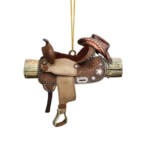 Close-up of Western cowboy saddle and hat pendant with golden rope for car mirror decor