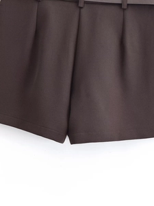 Detailed close-up of dark charcoal shorts featuring twill fabric and matching belt