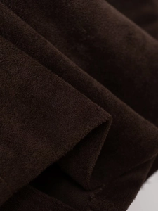 Macro shot of brown faux suede fabric showing soft texture and draping of the shirt jacket
