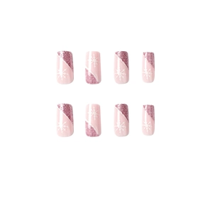 Pink press on nails with white snowflake patterns and glitter in French manicure style