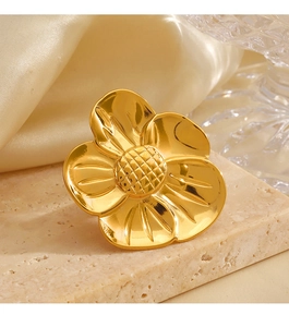 Close-up of a large 18K gold plated flower ring with detailed petal textures and grid core