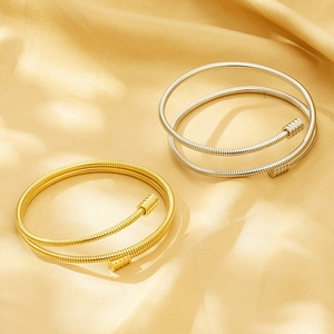 Elegant 18k gold and silver multilayer cable spring open bracelets on satin fabric