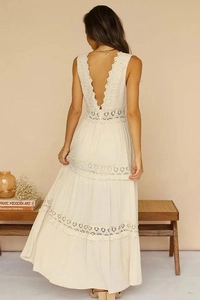 Detailed back view of an off-white lace maxi dress featuring an elegant V-back design