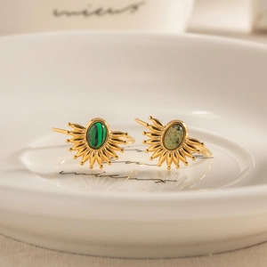 French vintage style natural stone rings with gold sunburst design in a white bowl