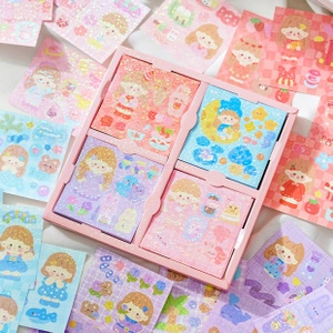 Macro detail of sparkly macaron-colored stationery stickers and pink gift box set