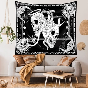Detailed view of gothic tapestry with skull and moon phases hung over a grey sofa