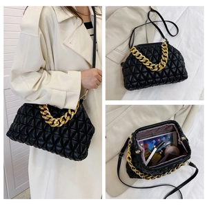 Quilted shell bag featuring gold chain handle and interior storage capacity view