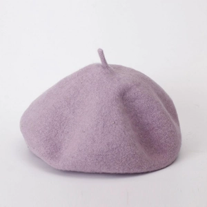 Close-up of the soft purple wool fabric texture and clean stitching of the beret hat