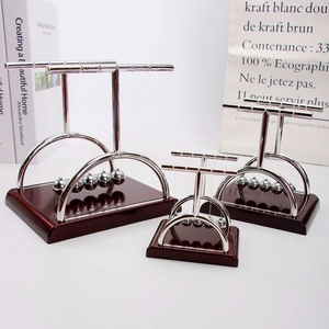 Three sizes of Newton's Cradle with mahogany base and silver metal swinging balls