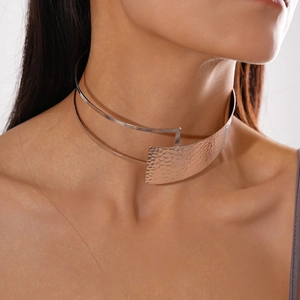 Detail of metallic asymmetric double-layer choker with hammered texture on model