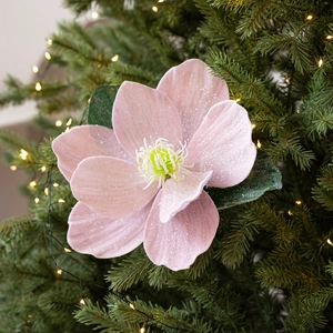Pink velvet lotus ornament with glitter and frosted leaves on a Christmas tree