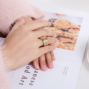 Detail of three-tone interlocking rings in gold, rose gold, and silver with pavé crystals