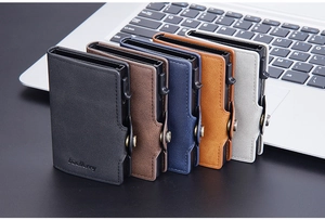 Multiple slim RFID blocking card holders in five colors on a laptop keyboard