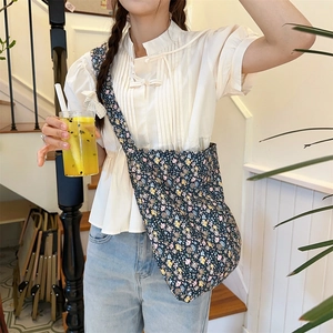 Detail of trendy leopard floral canvas tote bag with adjustable shoulder strap on model