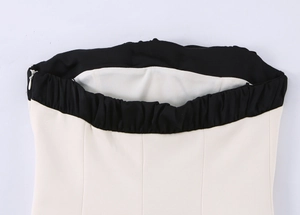 Gros plan du haut bustier bicolore crème et noir avec fermeture éclair invisible