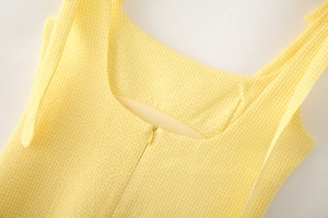 Detail of yellow gingham dress neckline with back invisible zipper and fabric texture
