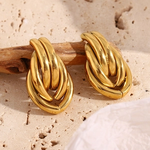 Detail of twisted multi-layer golden 18K gold-plated oval chain link stud earrings
