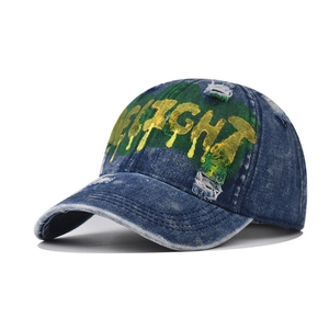 Vintage washed denim baseball cap with yellow Delight text and green graffiti paint design