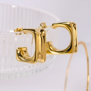 Modern 18k gold plated stainless steel square C-shaped earrings on glass edge