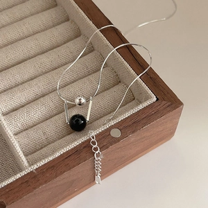 925 sterling silver necklace with black agate beads on beige velvet jewelry box tray