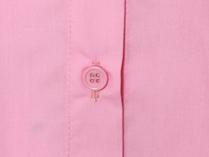 Close-up of pink embroidered shirt placket showing button detail and fabric texture
