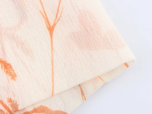 Details des Chiffonkleid-Stoffs mit atmungsaktiver Textur und orangefarbenem Blumendruck