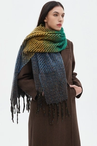 Detail of multi-color striped knit scarf with gradient fringe and textured woven fabric