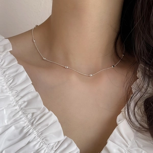 Elegant 925 sterling silver bead necklace with olive spacers on model wearing white shirt