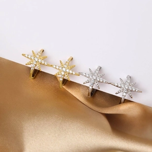 Minimalist star ear cuff with zircon inlay in gold and silver finish on silk