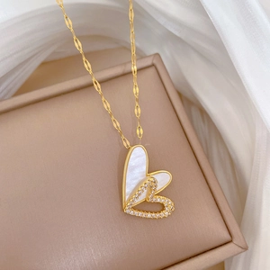 Close-up of double heart pendant with white mother of pearl and crystals on silk
