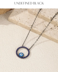 Macro shot of S925 silver evil eye pendant with blue crystals on stone background