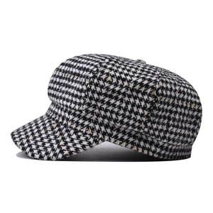 Classic houndstooth plaid newsboy cap in black and white with a structured vintage design