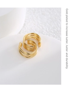 Detail showing gold-plated multi-layer hoop clip earrings on a white stand