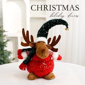Christmas reindeer plush figurine with sequins and bells on a white tabletop setting