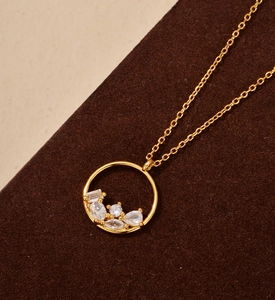 Close-up of golden S925 sterling silver necklace with clustered mixed-cut zircon stones