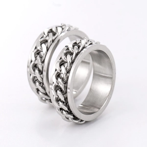 Titanium steel spinner ring with rotatable silver Cuban chain link on white background