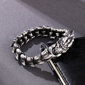 Detailed close-up of punk style dragon head bracelet in antique silver steel finish