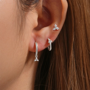 Close-up of S925 silver earring set featuring triple diamond flower studs and hoops