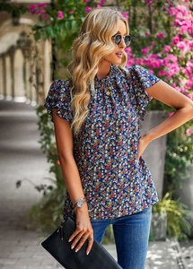 Detail of floral ruffle sleeve blouse in navy blue with colorful flower pattern