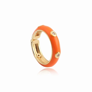 Detailed macro view of orange enamel ring with AAA zircon accents on gold plated band